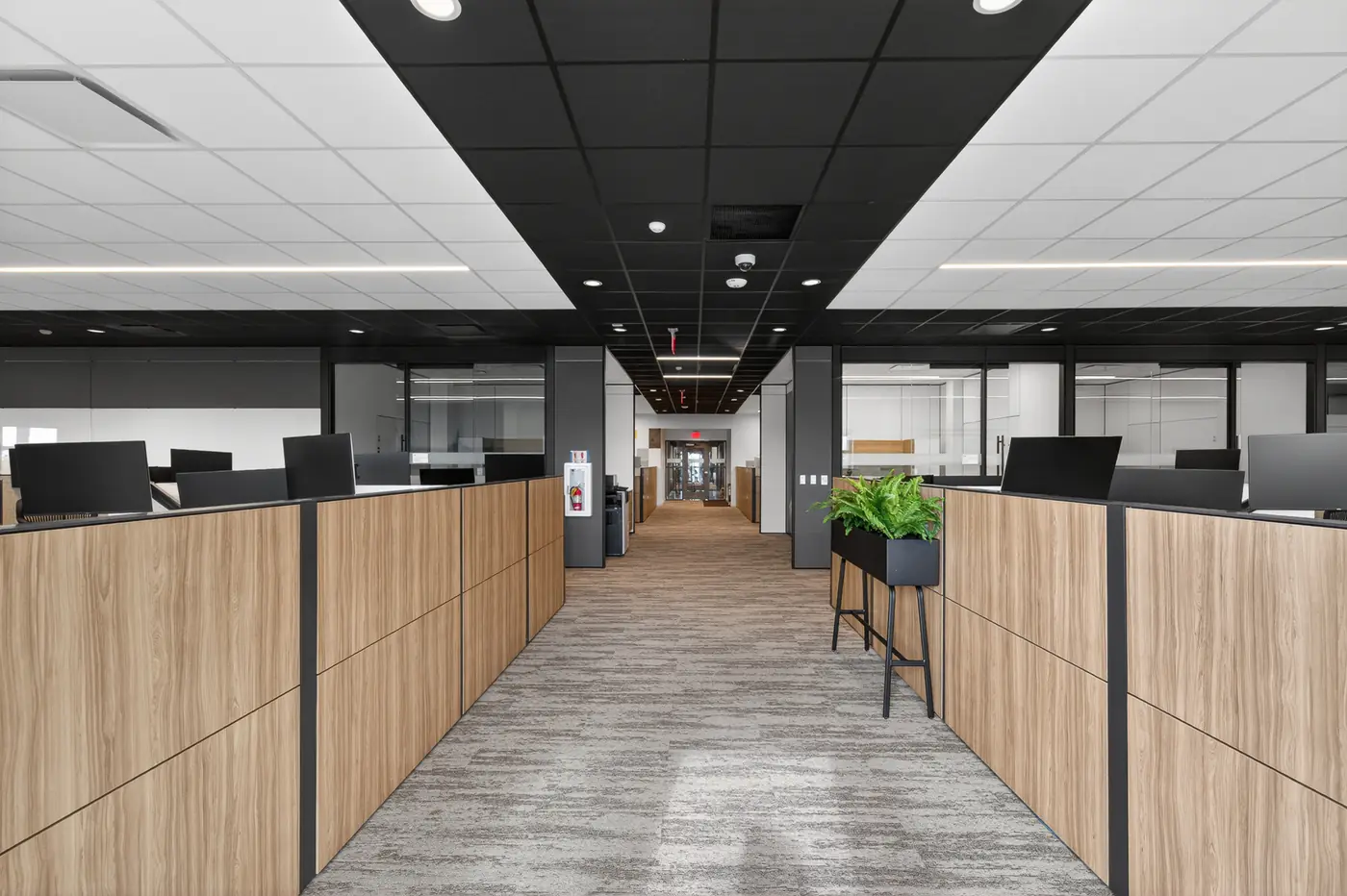 Modern open office interior with a dark ceiling band and finished walls