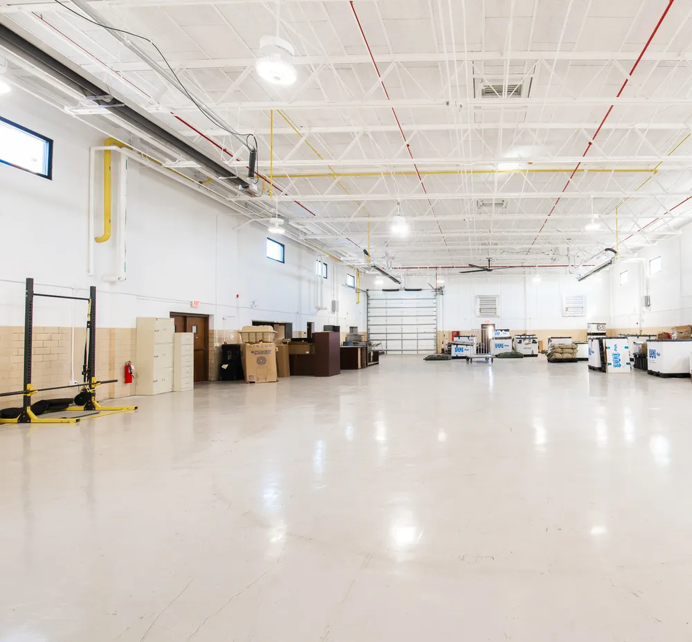Large painted interior hall with exposed structure